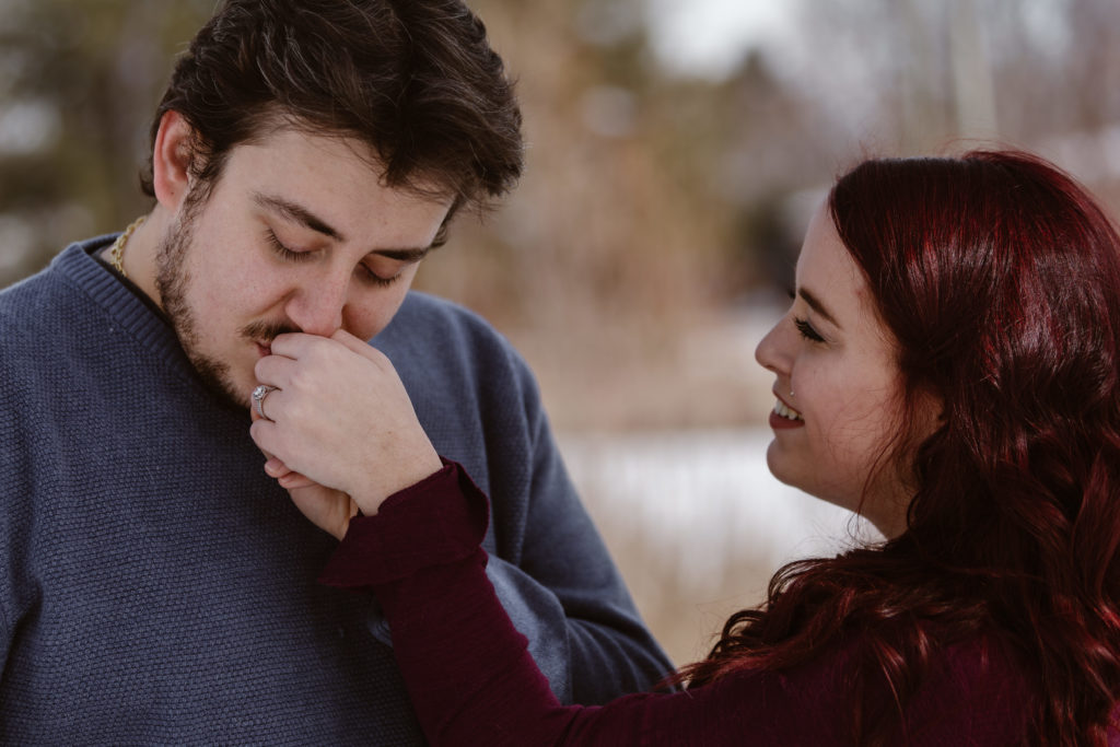 Man kissing fiancé's hand
