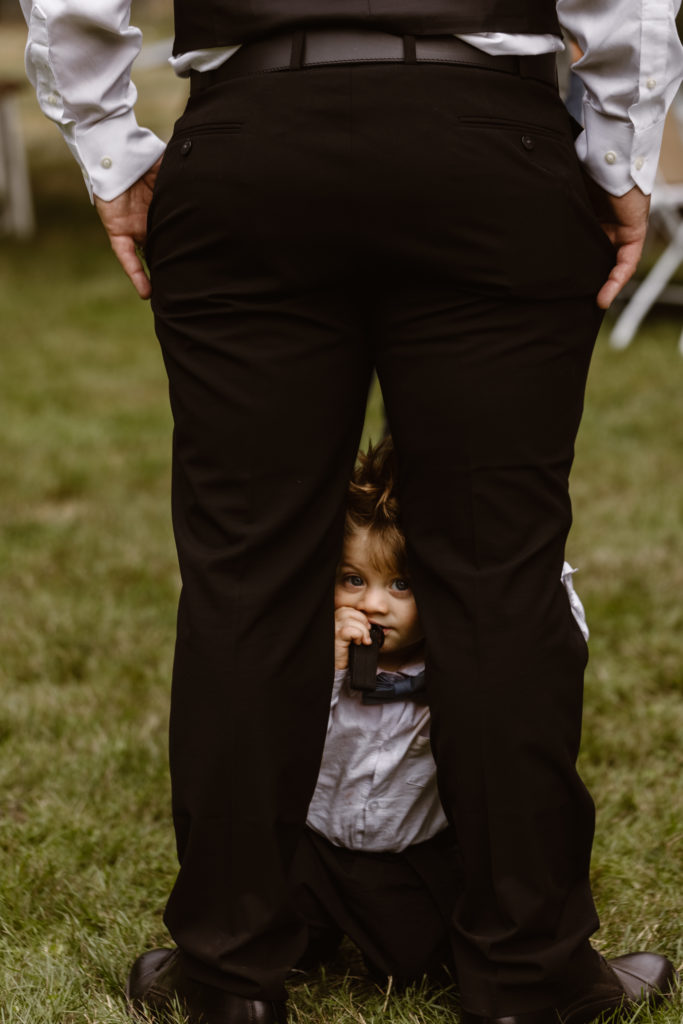 Son peaking through dad's legs.