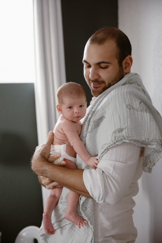 Dad holding newborn baby