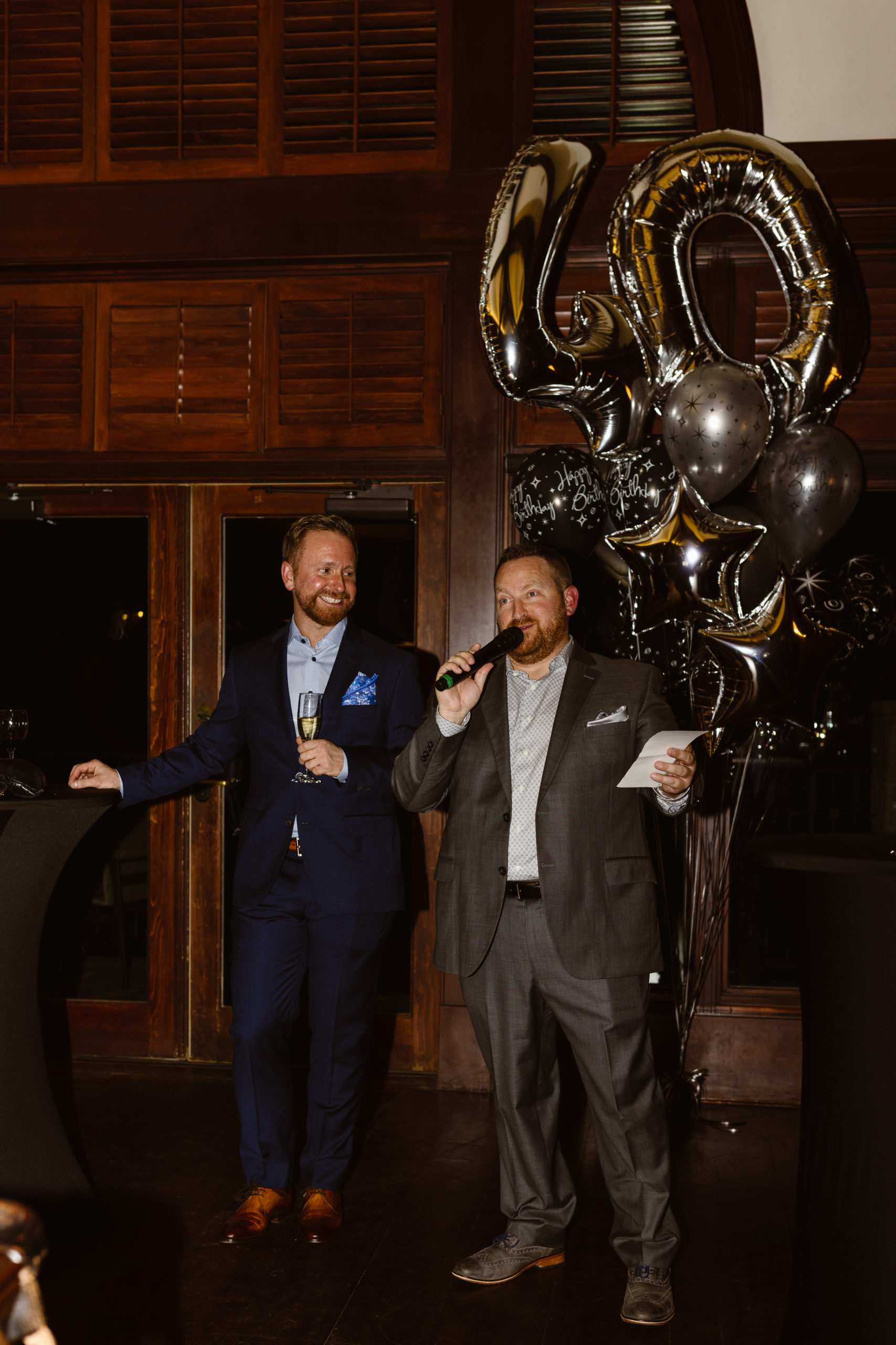 Candid of people smiling during a toast at a 40th birthday party