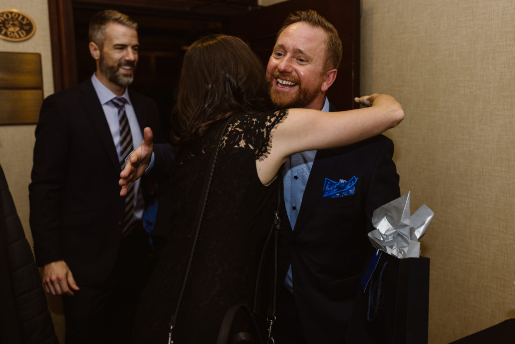 Birthday boy hugging a guest leaving his party.