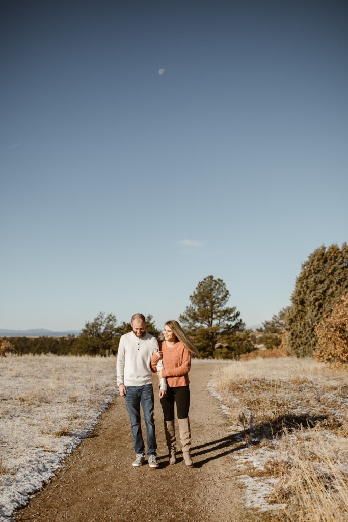 Couple with arms linked walking toward the camera
