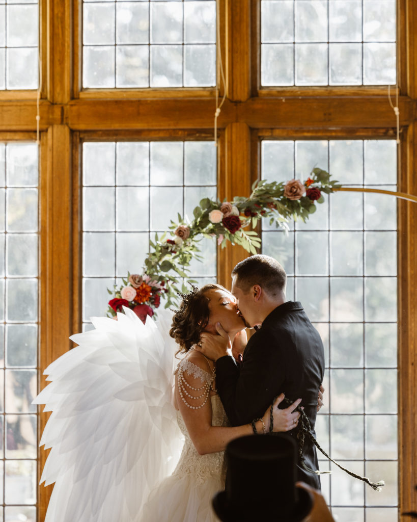 Bride and groom first kiss after ceremony.