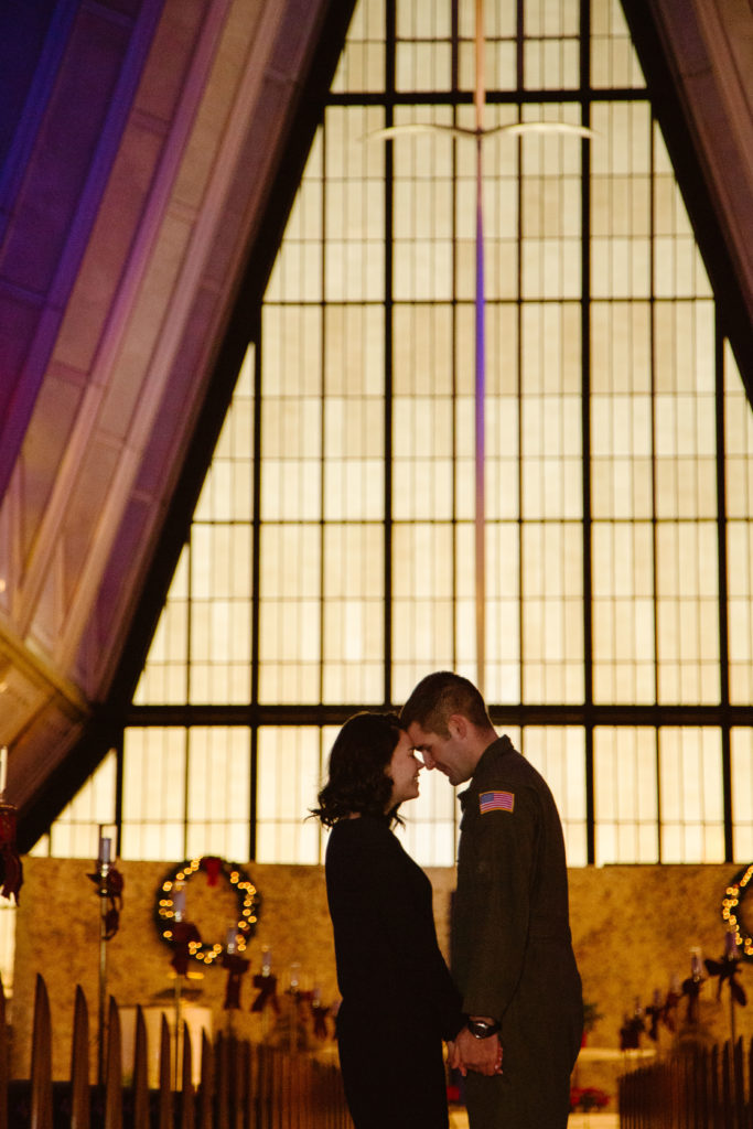 Man in Air Force uniform in the United States Air Force Academy Cadet Chapel with his fiancé