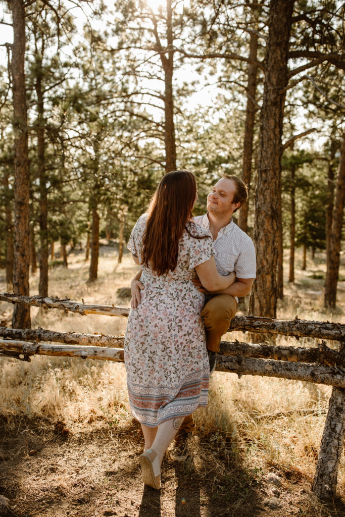 Couple with arms around each other looking at one another