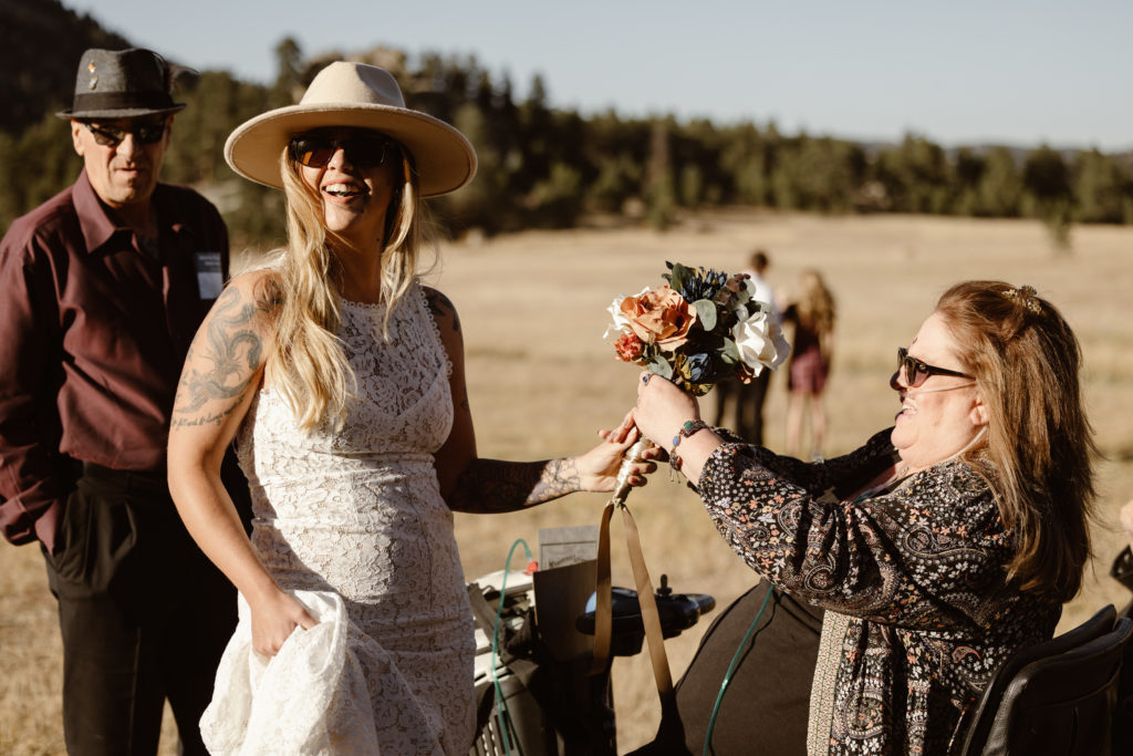 Bride and bride's mother doing final touches on flowers