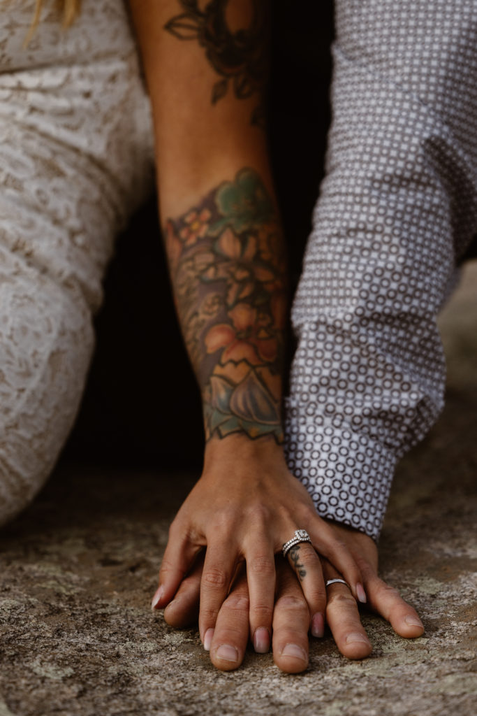 Bride and groom hands with wedding rings on