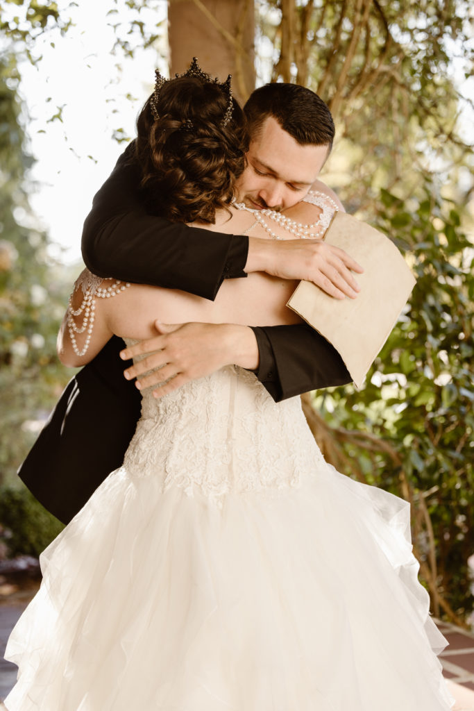 Bride and groom hugging after reciting vows.