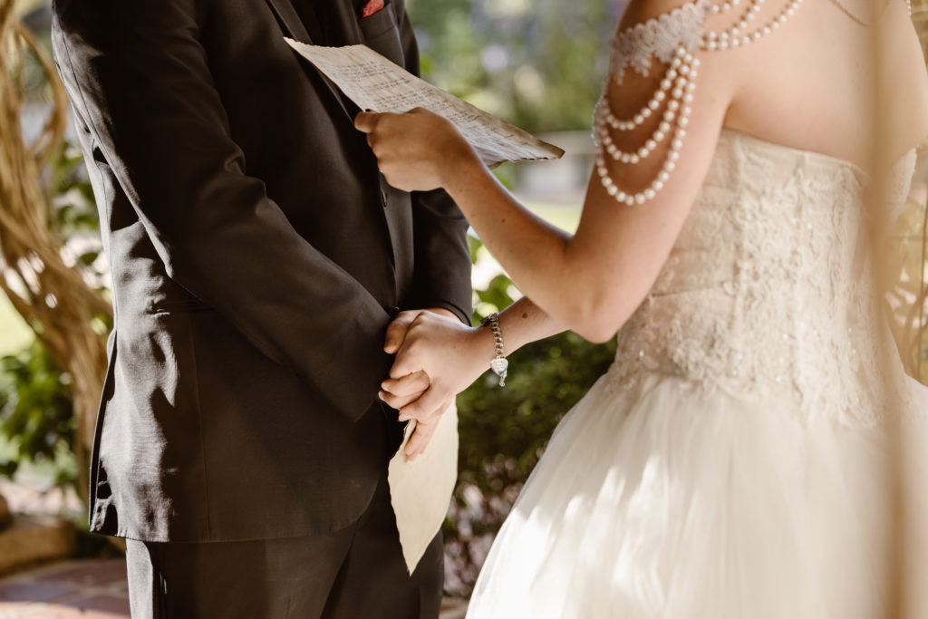 Reciting vows, holding hands.
