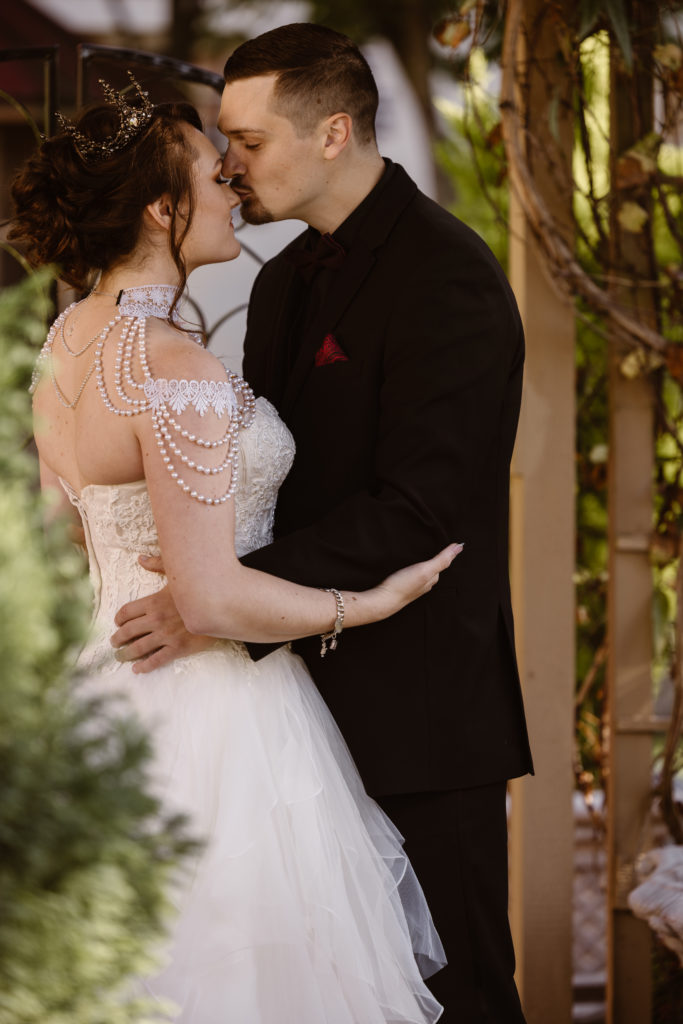 Groom kissing bride's nose.