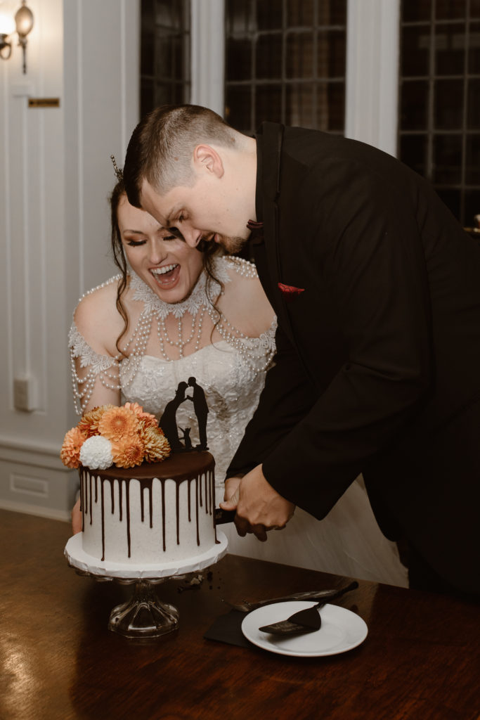 Bride and groom cutting their wedding cake.