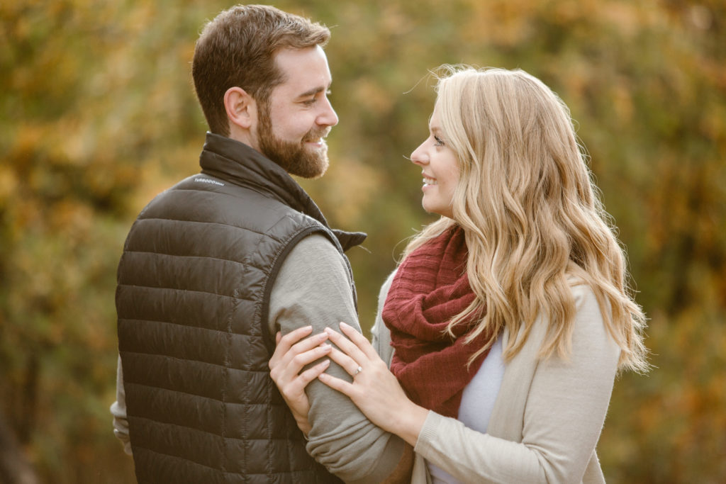Couple looking at each other, arms linked