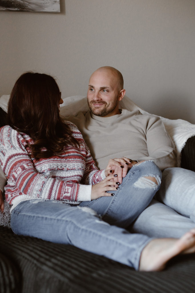 Couple cuddled on their couch
