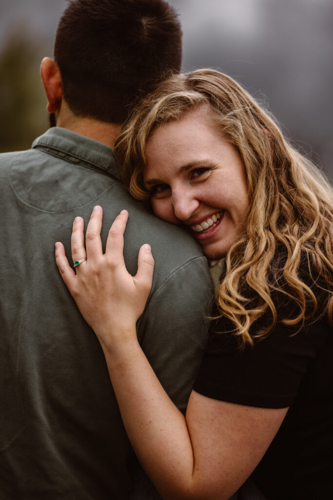 Woman looking over her fiancé's shoulder smiling