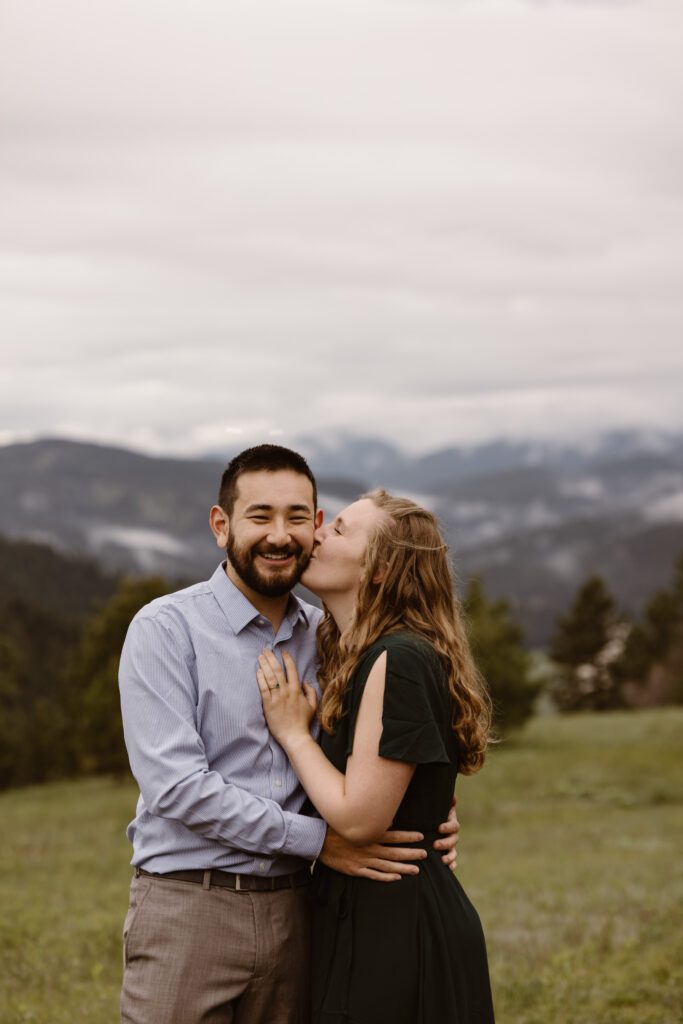 Woman kissing her fiancé on the cheek