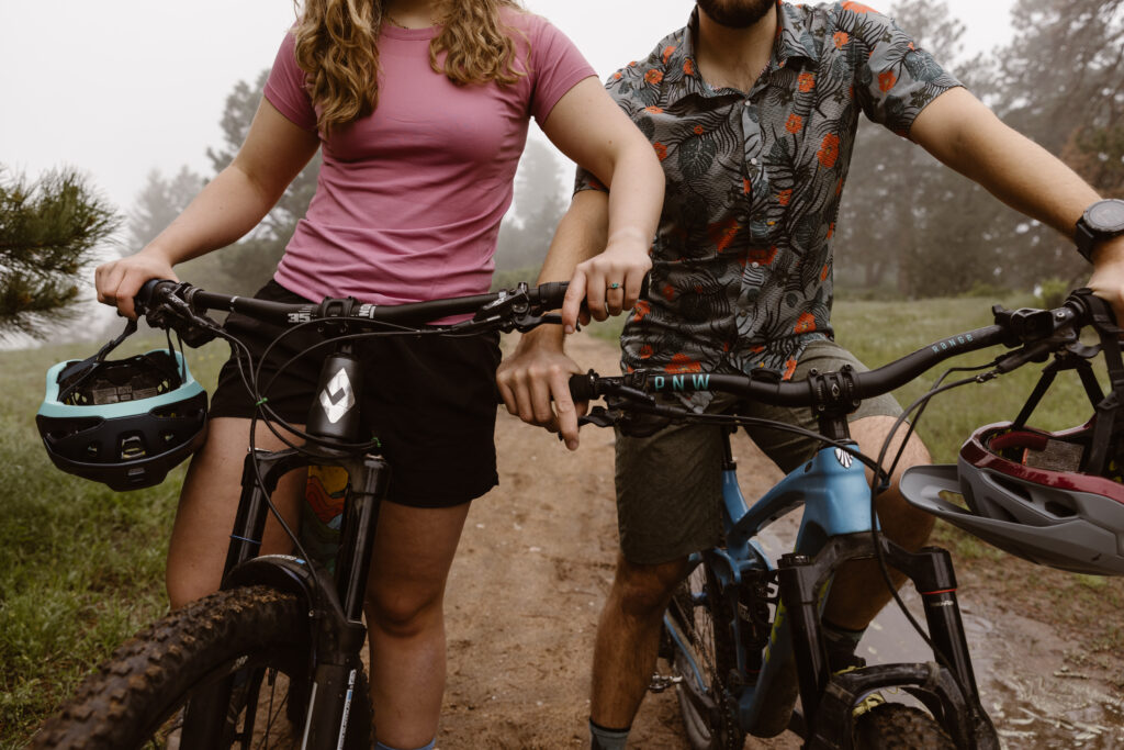 Engaged couple on their bikes standing next to each other