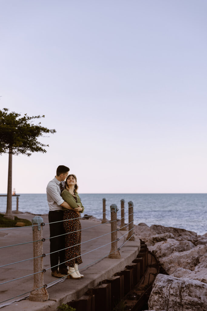 Man holding woman from behind looking at her