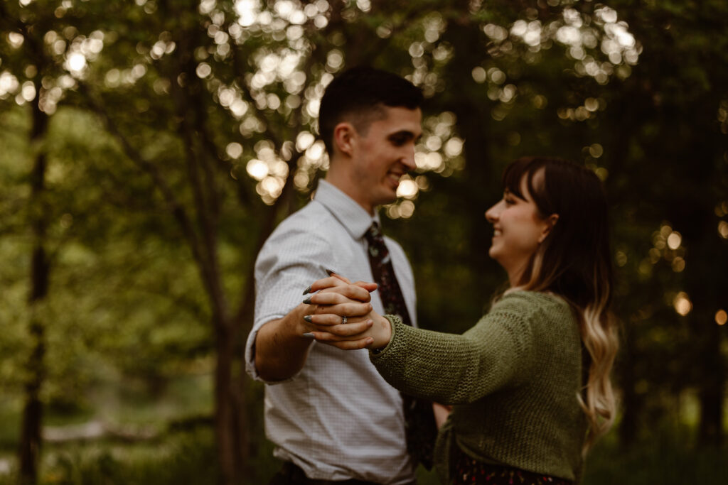 Couple holding hands with their arms out