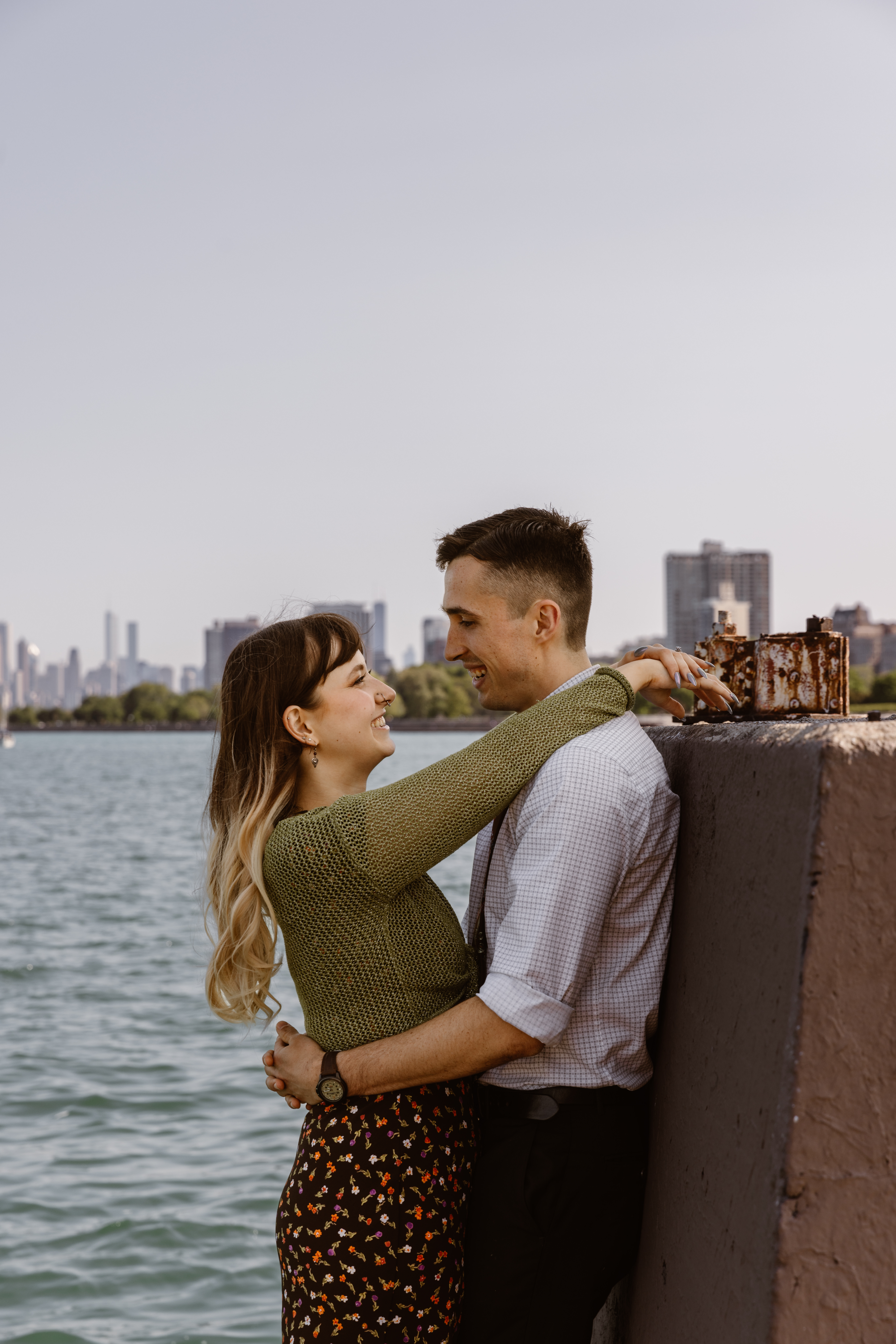 Woman with her arms over her fiancé looking into his eyes