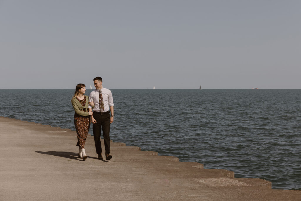 Couple walking next to the water line
