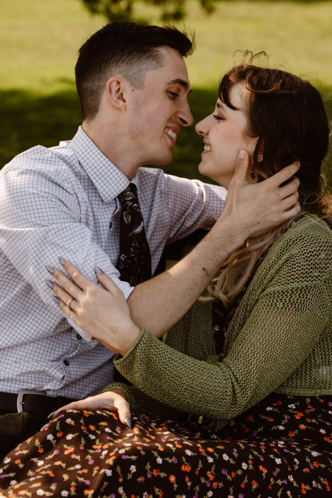 Couple about to kiss on a park bench