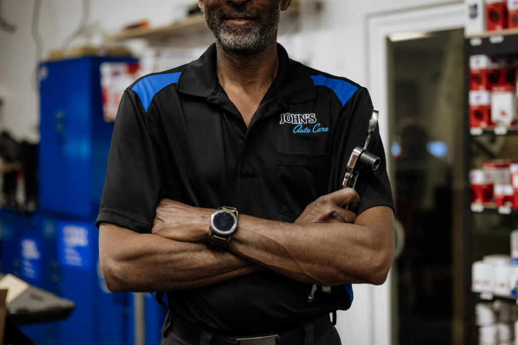 Posed photo of mechanic holding tools
