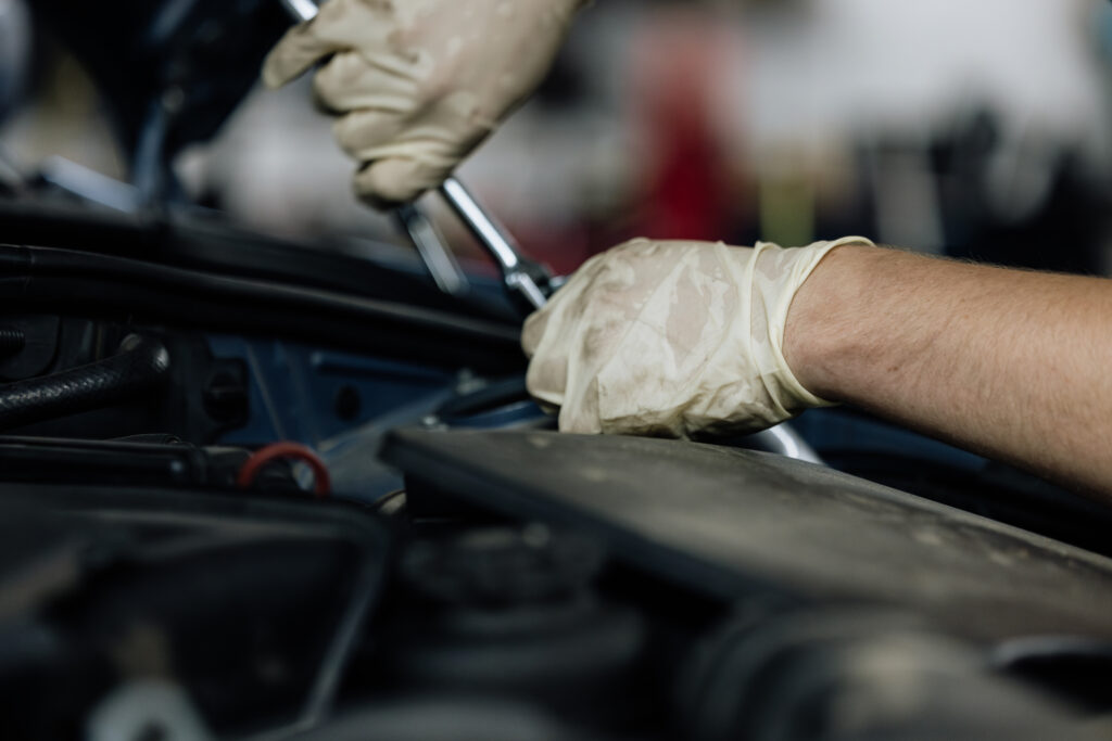 Hands working on a car's engine