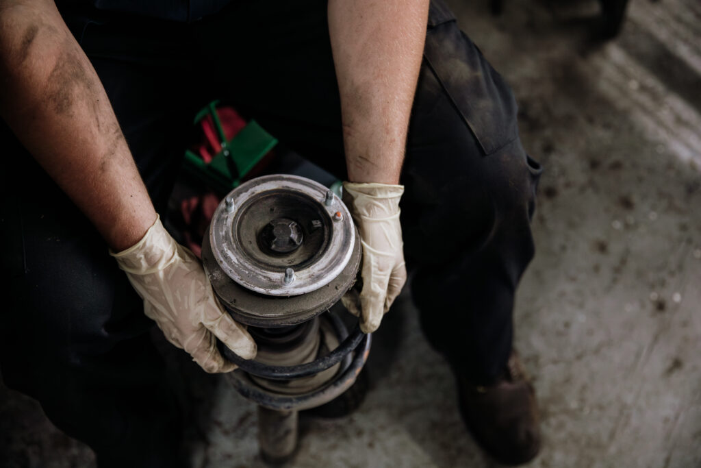 Mechanic holding car part