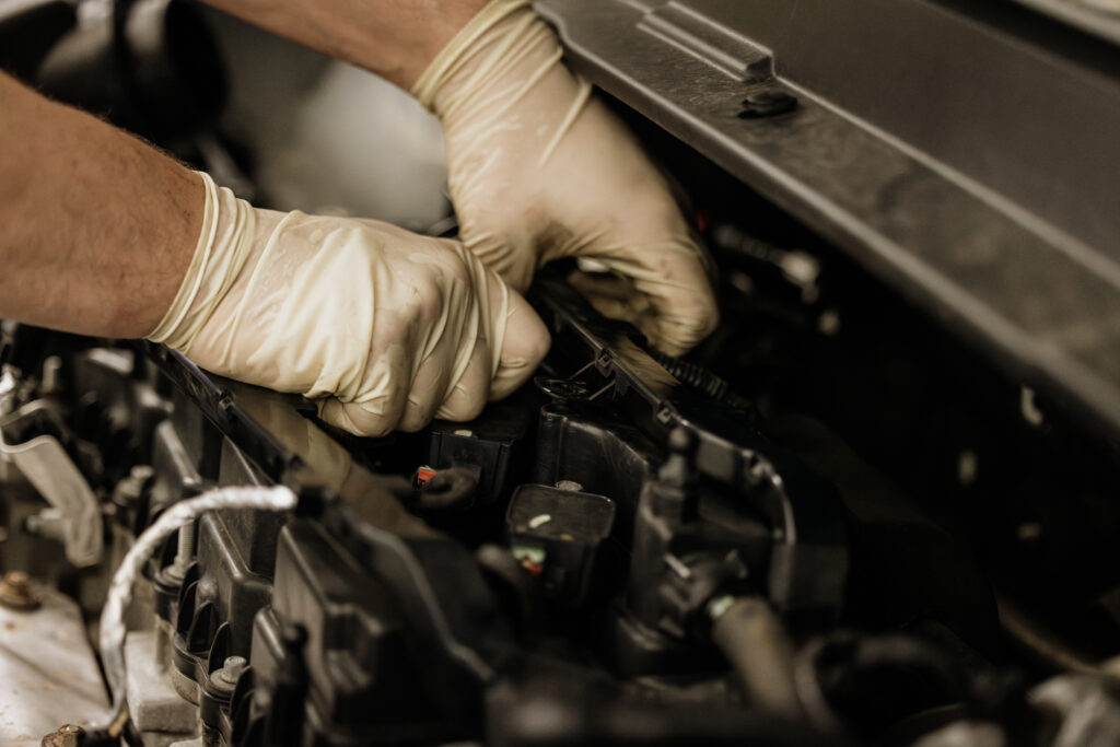 Mechanic's hands working on a car's engine