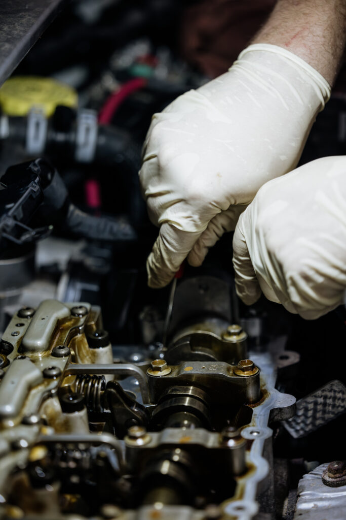 Hands working on a car's engine