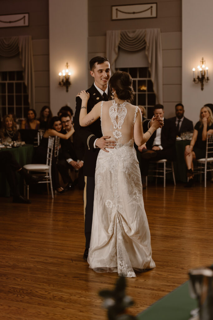 Groom looking at bride during their first dance as husband and wife