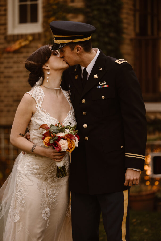 Bride and groom portrait sharing a kiss
