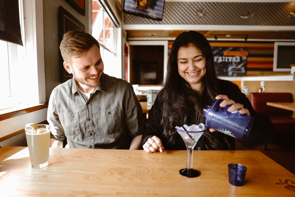 Woman pouring her drink at a Chili's with her fiancé