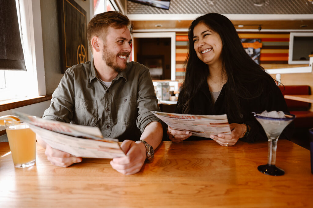 Engaged couple looking over the menu at Chili's