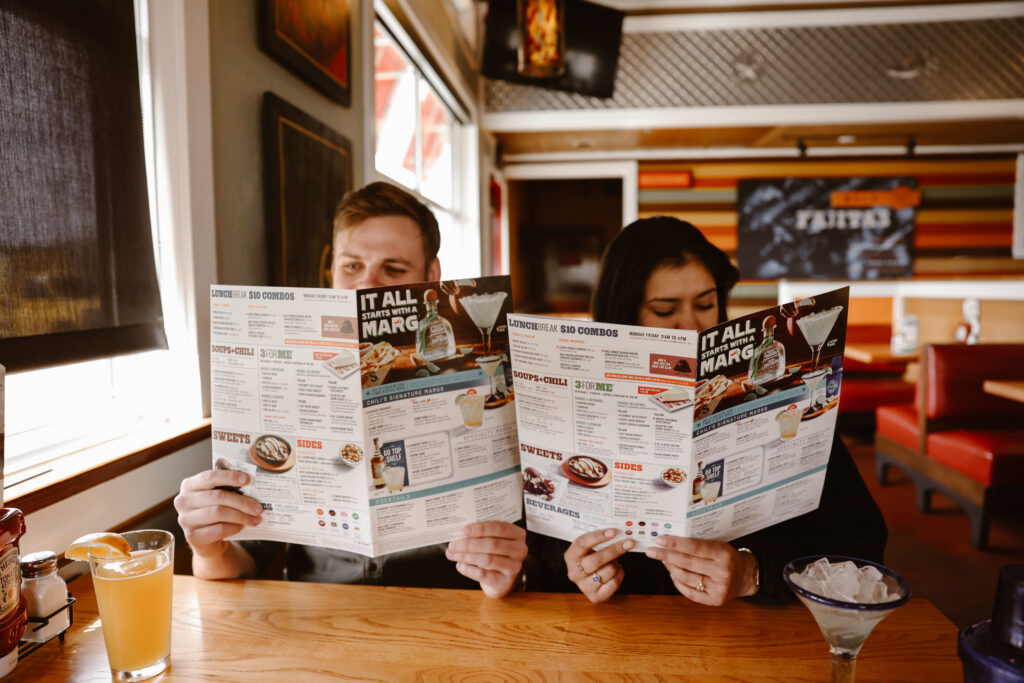 Engaged couple looking over the menu at Chili's