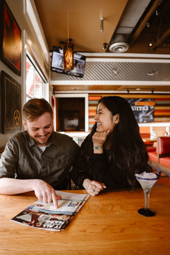 Engaged couple at a Chili's talking over a menu