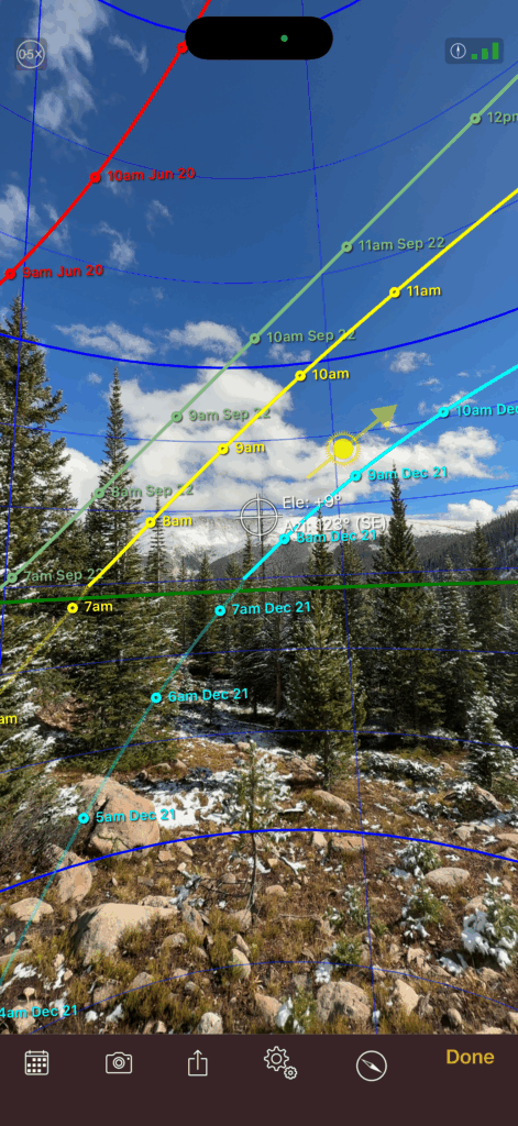 Sun path overlay showing the direction and elevation of the sun throughout the year over a mountain landscape in Winter Park, Colorado, used for photography and elopement planning.