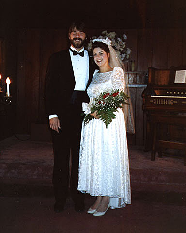 Bride and groom standing together inside a small chapel during their vintage Las Vegas elopement ceremony in the 1960s.