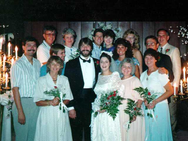 Bride and groom surrounded by family members during their vintage Las Vegas elopement celebration inside a chapel.